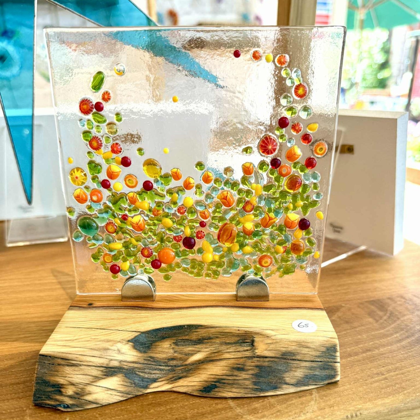 Fiery Art Glass piece showcased on wavy edged Elm block